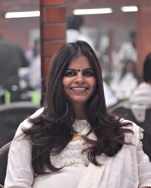 A smiling woman in a salon chair