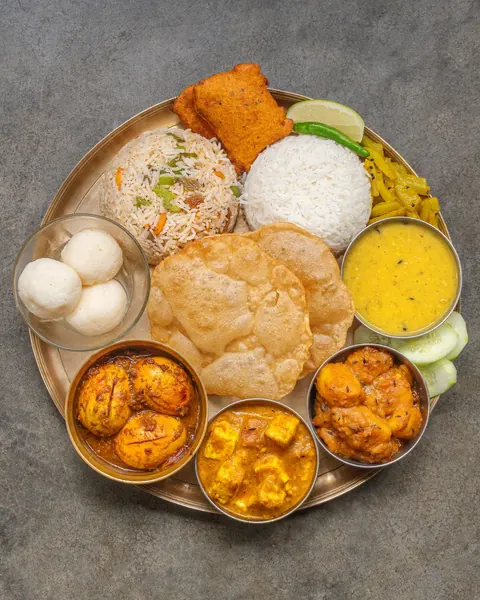 An Indian thali with rice, dal, curries and puri